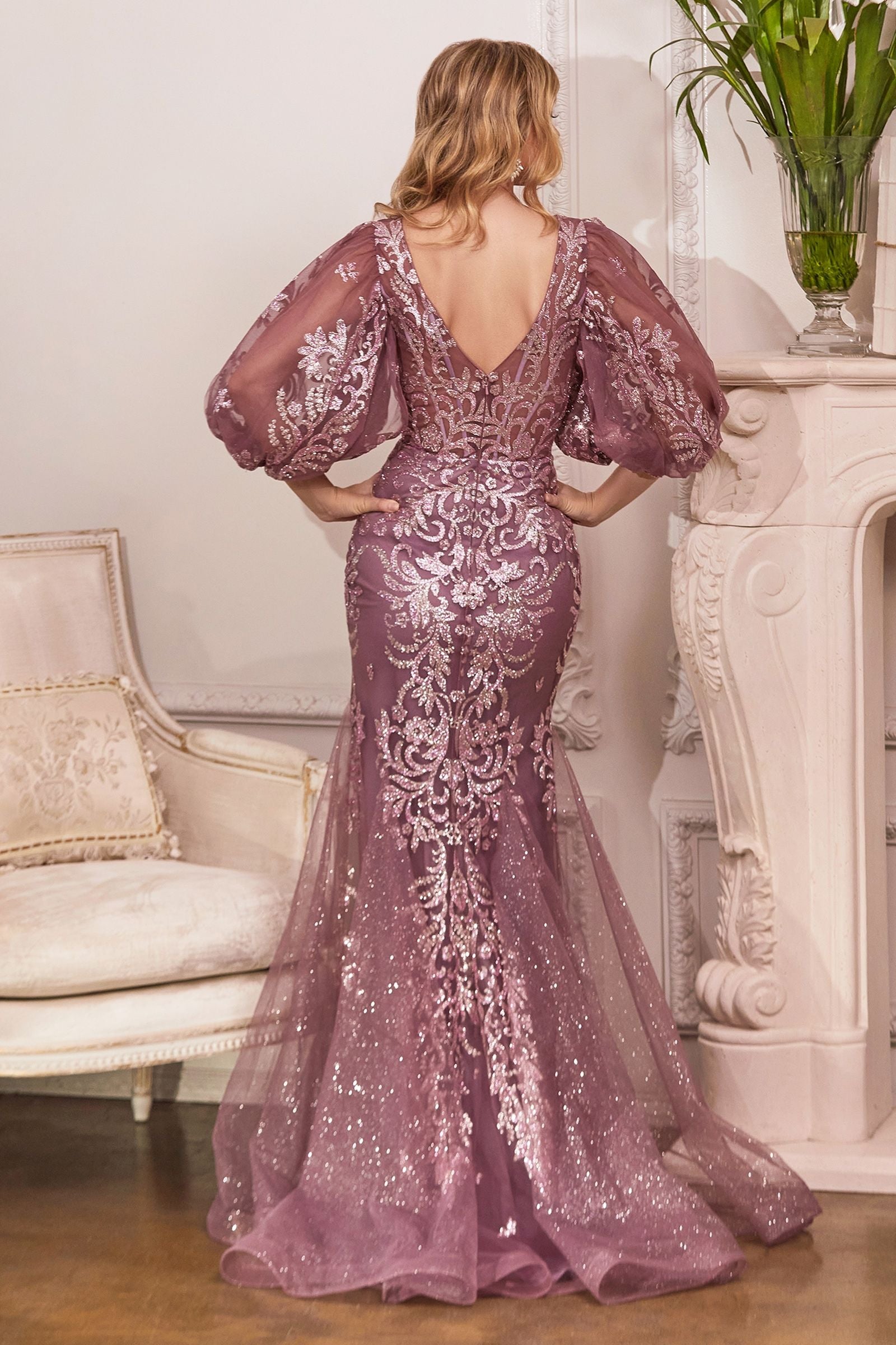 A mesmerizing mermaid gown with long sleeves, covered in radiant glitter