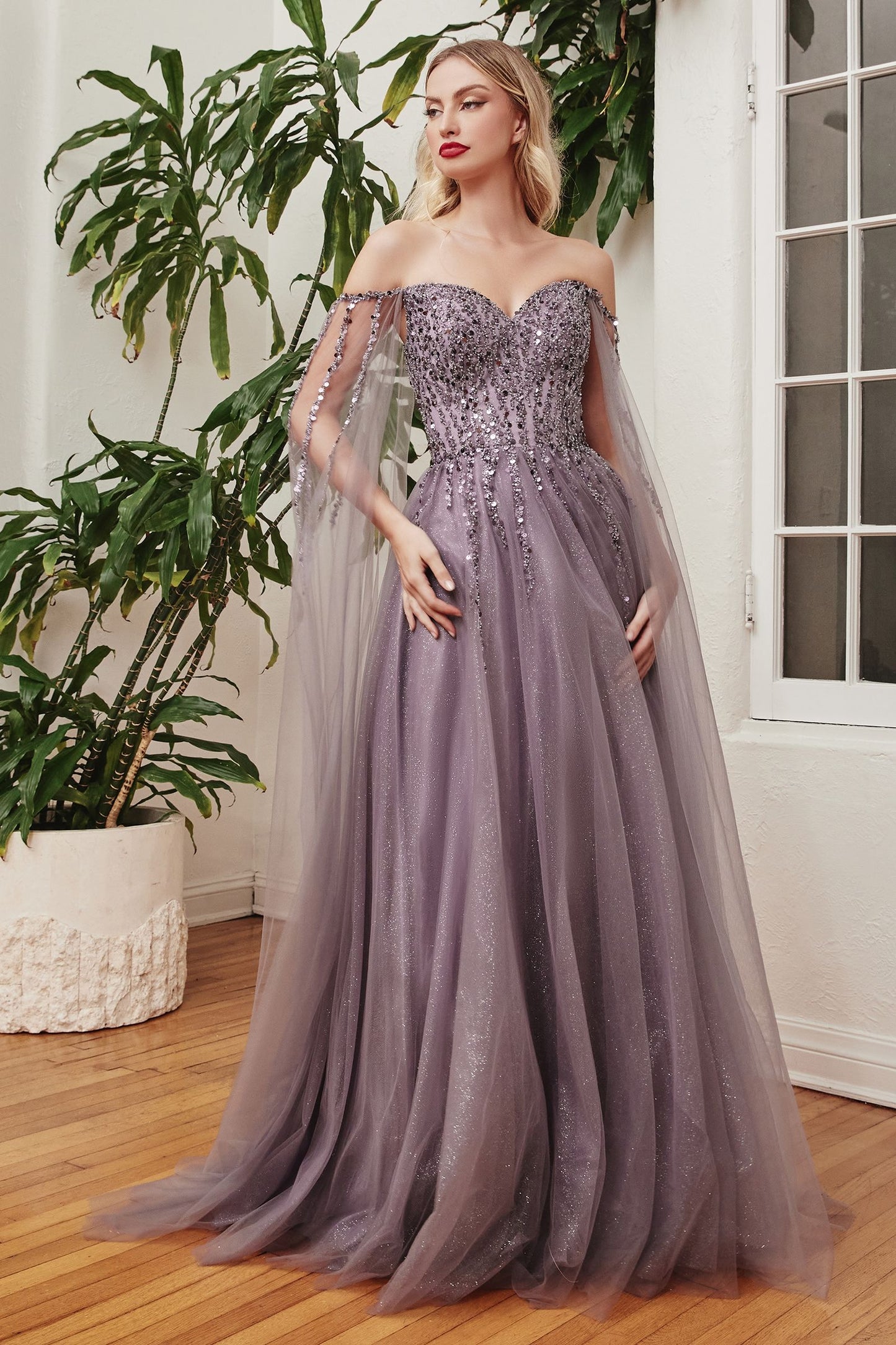 Mother of the bride sophisticated black evening dress featuring a beaded bodice and a floor-length skirt.