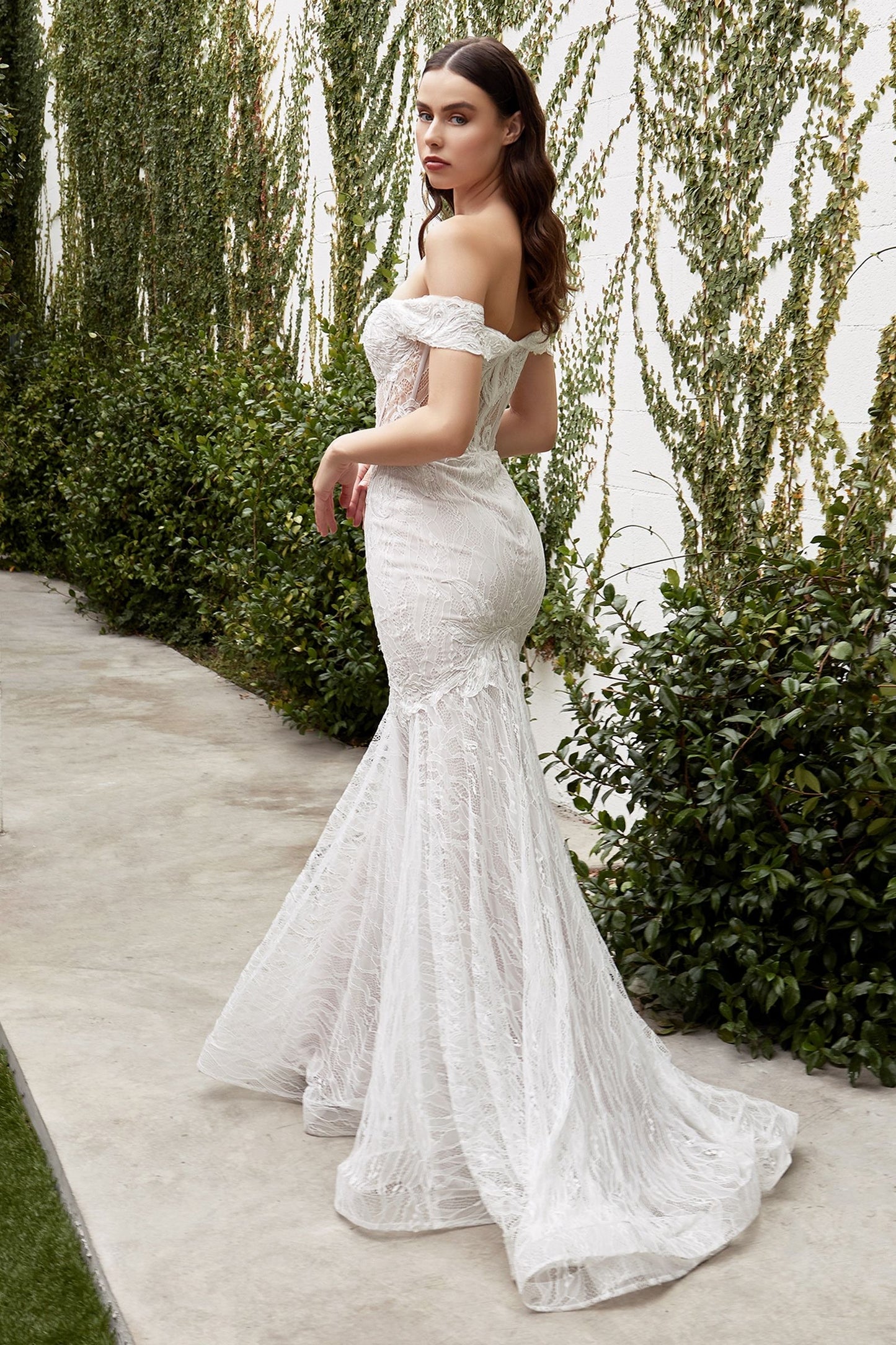 a classic a-line wedding dress in off white featuring a delicate lace overlay and a subtle train