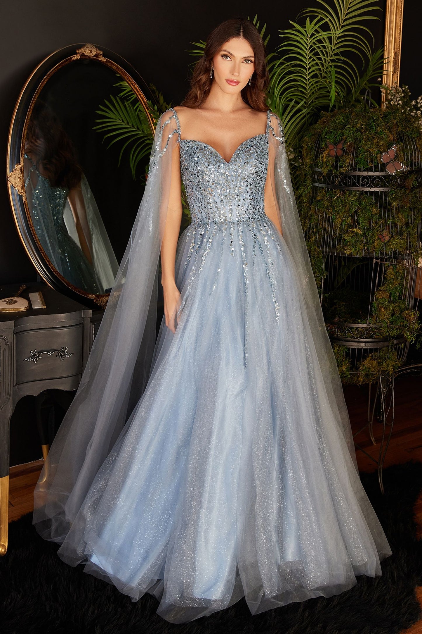 Blue stunning black evening gown with intricate beadwork and a flowing silhouette.