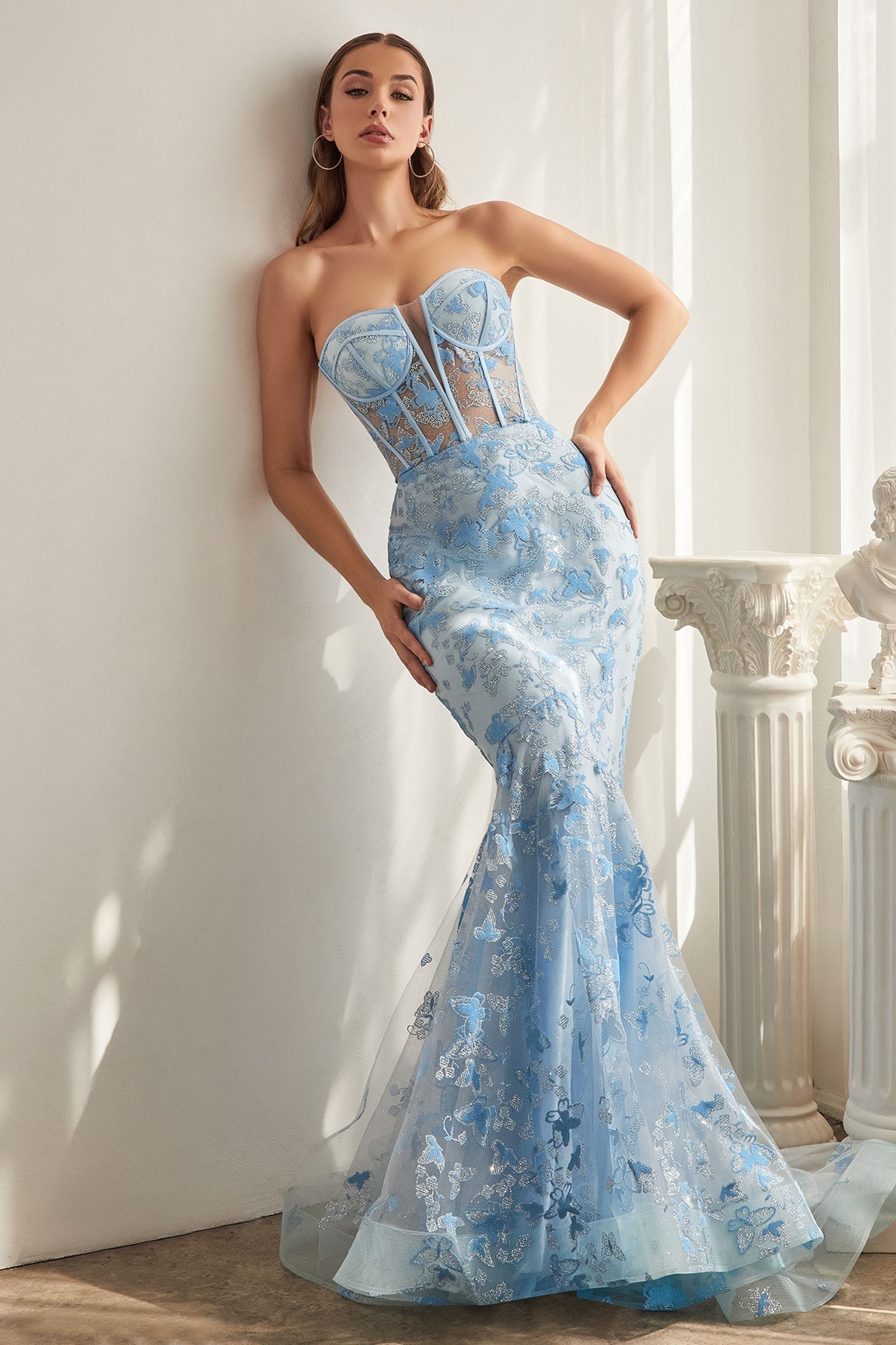 A sophisticated and alluring strapless mermaid gown with an eye-catching butterfly pattern.