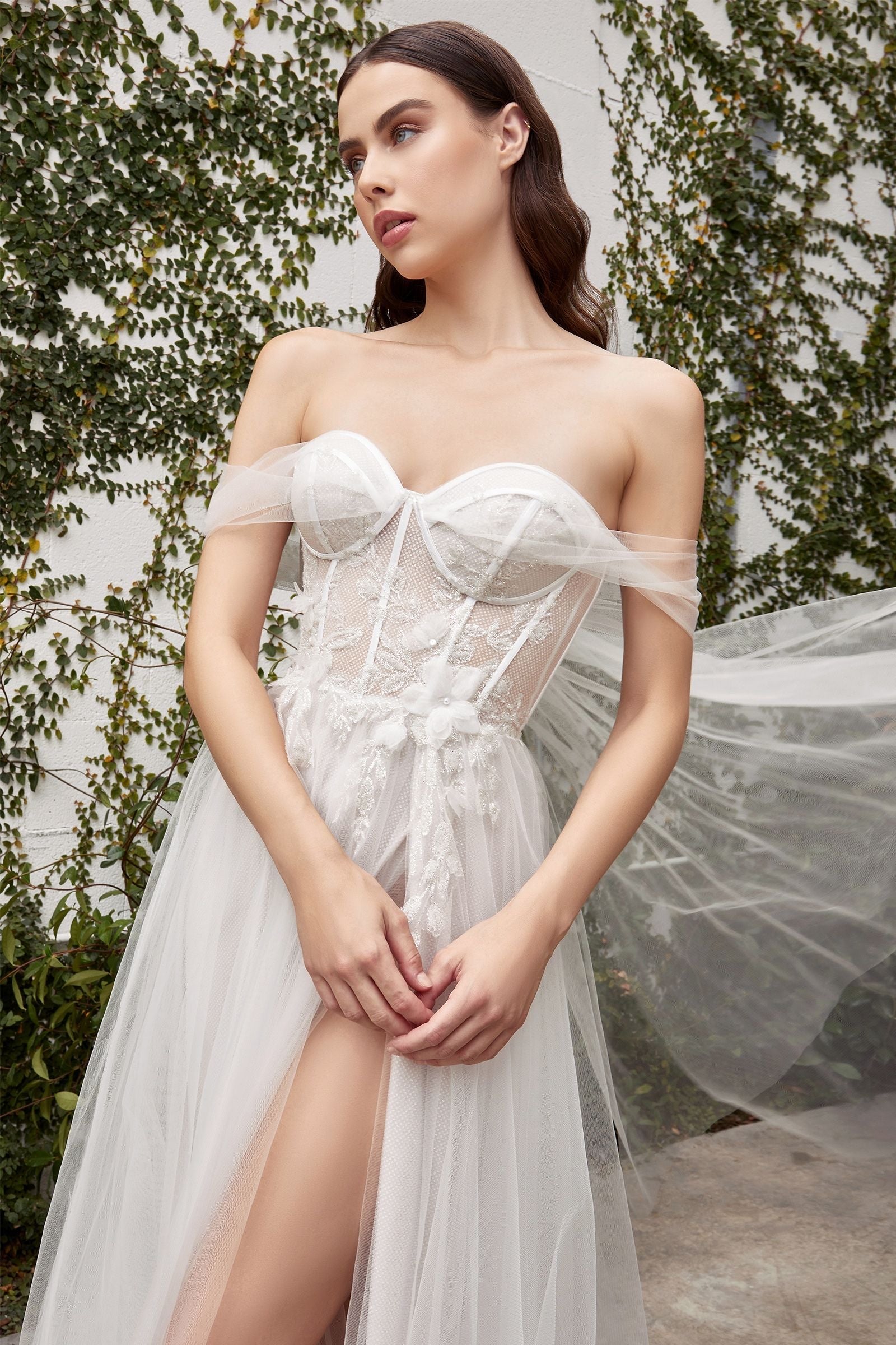 Romantic dress featuring a tie-back cape and delicate organza floral embellishments