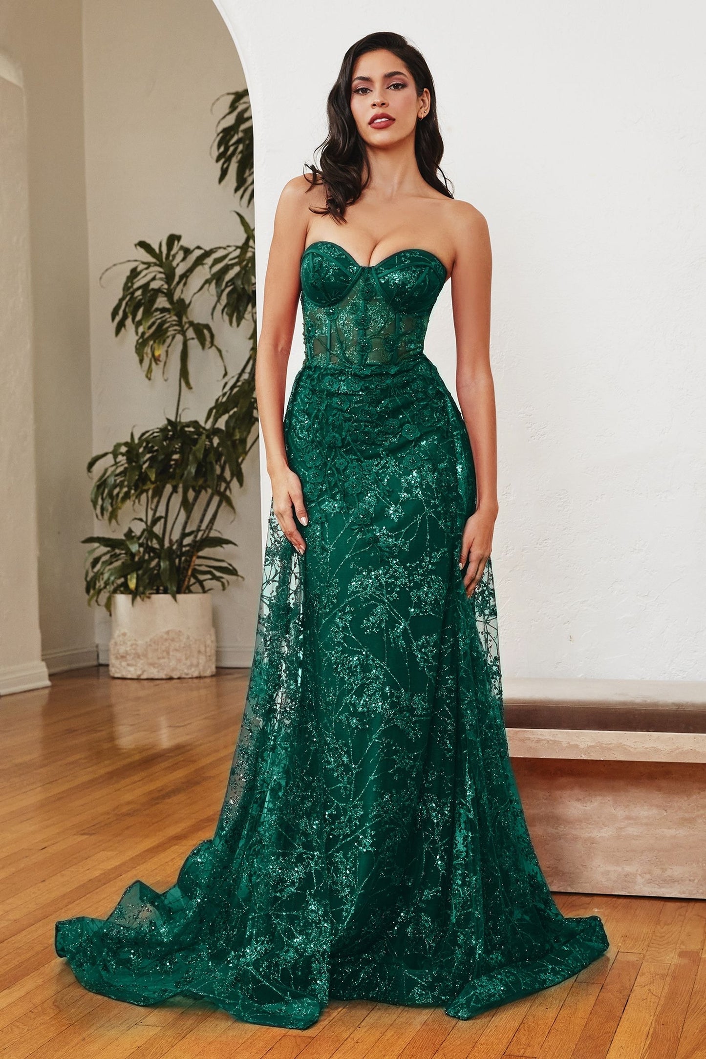 Mesmerizing strapless mermaid gown with a cascading overskirt for a captivating effect.