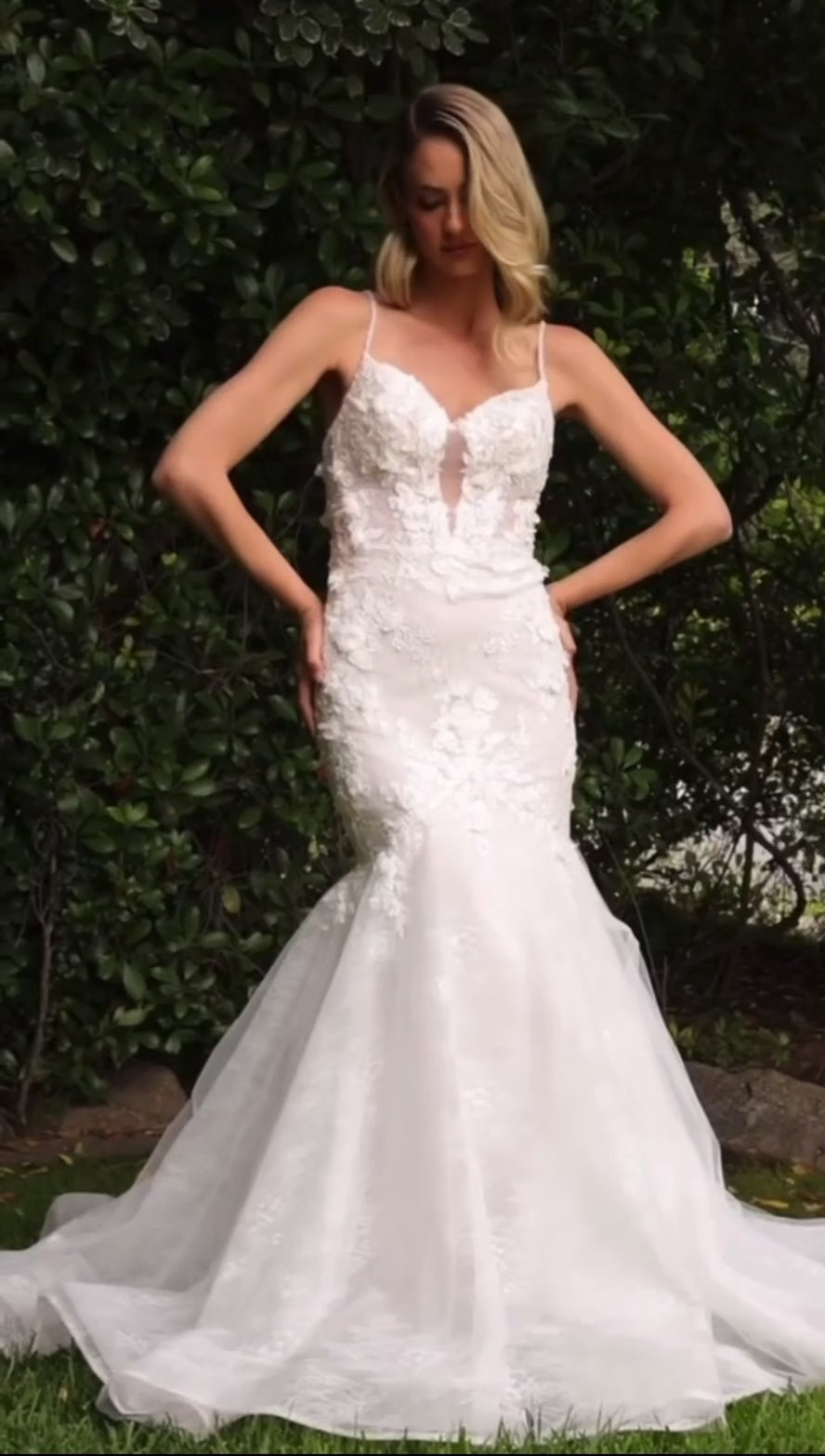 Glamorous lace mermaid wedding dress with dimensional floral applique and a subtle open back silhouette