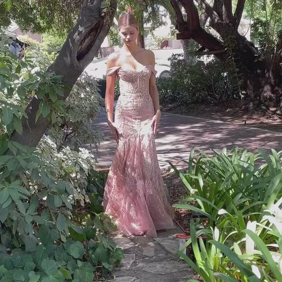 pink blush fitted gown with an off-the-shoulder neckline and a voluminous hem